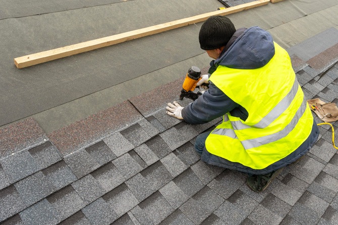 Roofing specialist installing a roof on a residential home